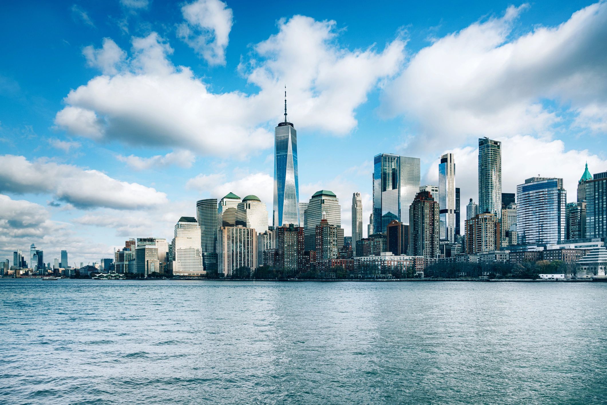 Manhattan skyline with One World Trade Center and blue sky